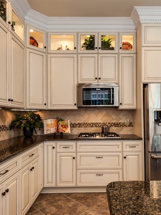 Cream cabinets with dark granite countertops